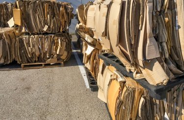 Bales of cardboard illustrating a guide on how to prepare cardboard for recycling