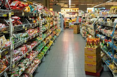 aisle in retail with filled shelves on both sides